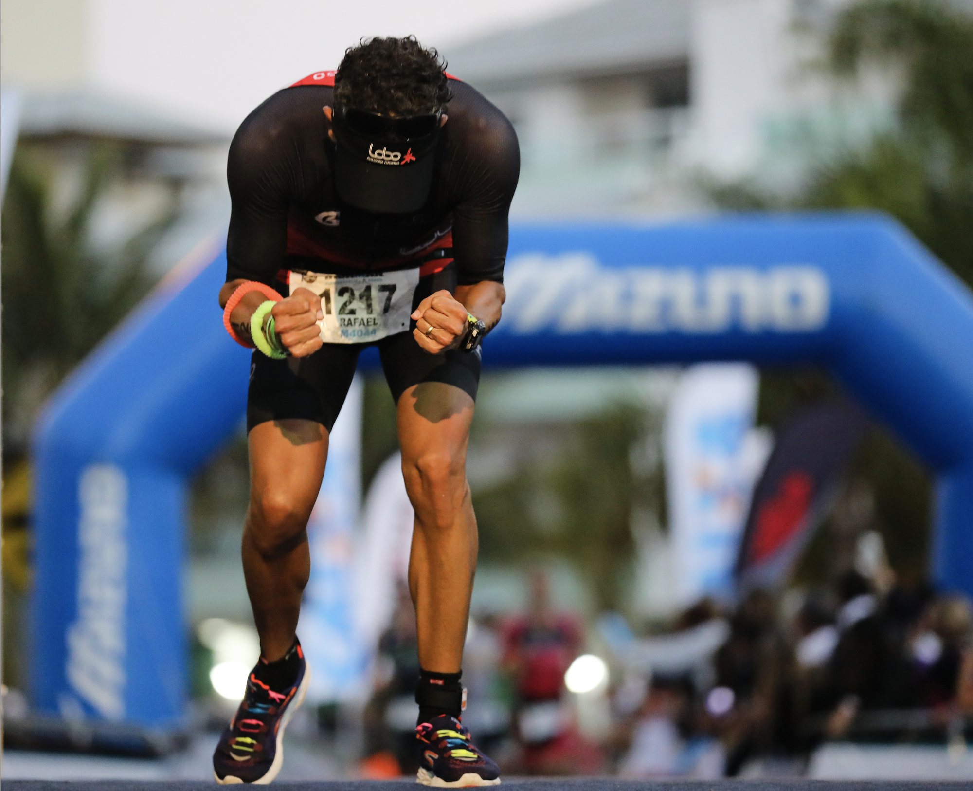 A triathlete at the finish line after racing at speed